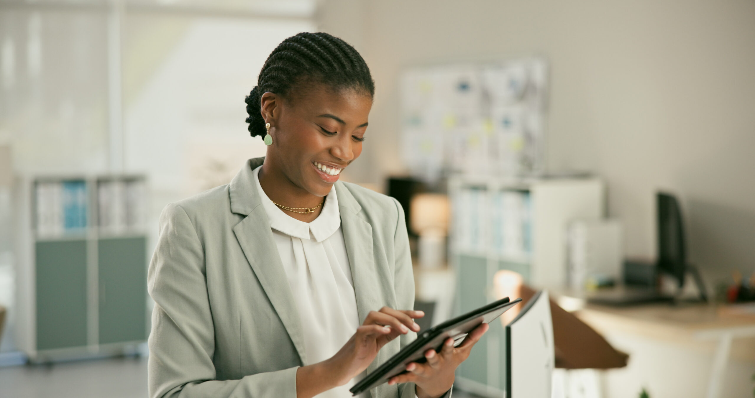 Happy black woman on tablet conducting research looking towards building trust with online reviews